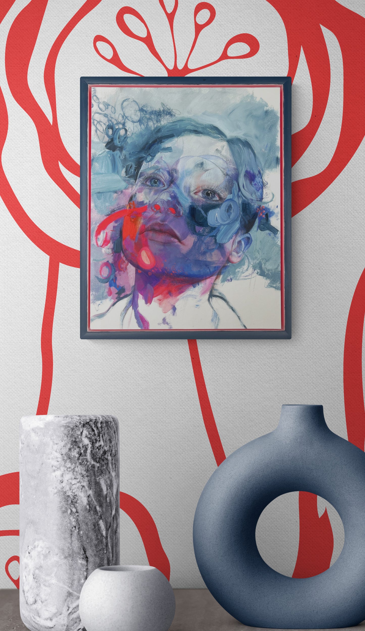 Framed abstract porrtait on red and white wall with vases