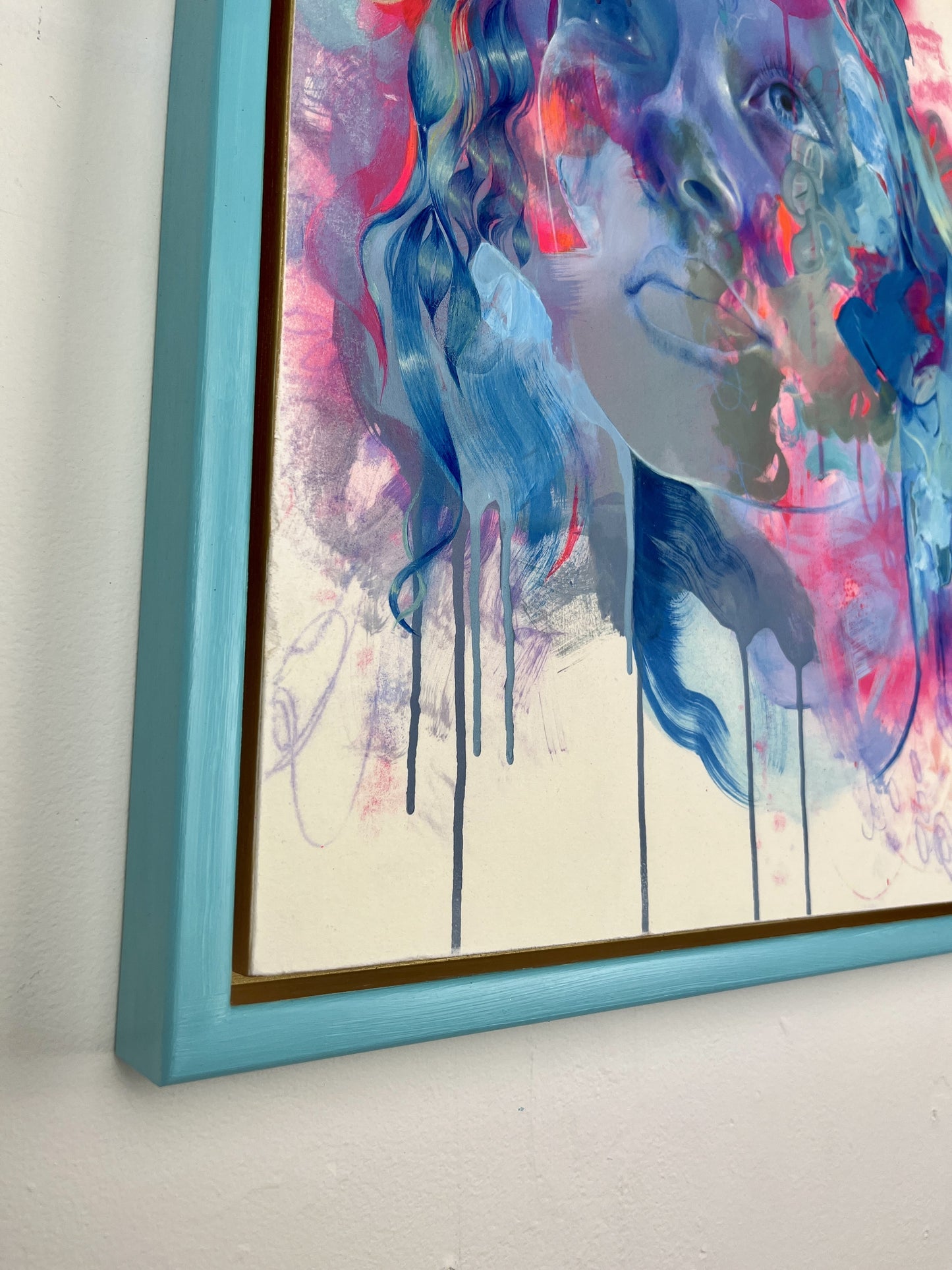 close up of corner of blue framed artwork